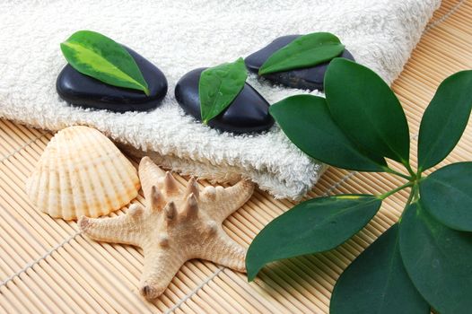 towel and zen stones showing a bath or wellness concept