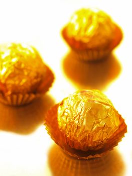 close up of candy with gold wrappers