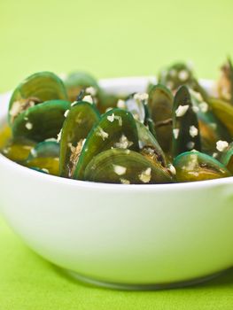 bowl of green mussels in garlic sauce