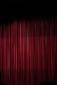 View of a red curtain of a theater stage.