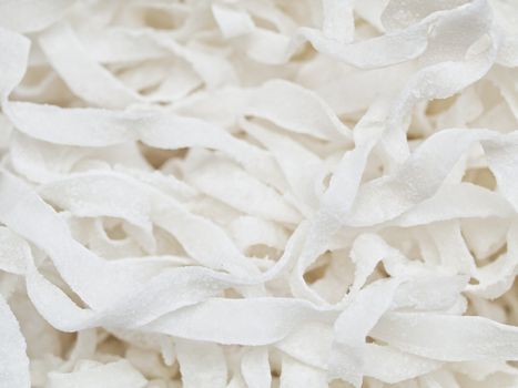 Closeup of a pile of white coconut stripes