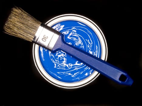 Blue Paint can and brush from above on black background
