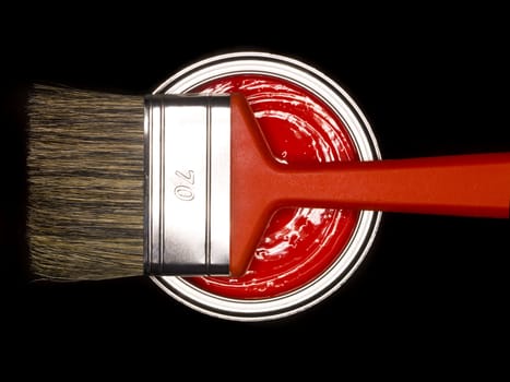 Red Paint can and brush from above on black background