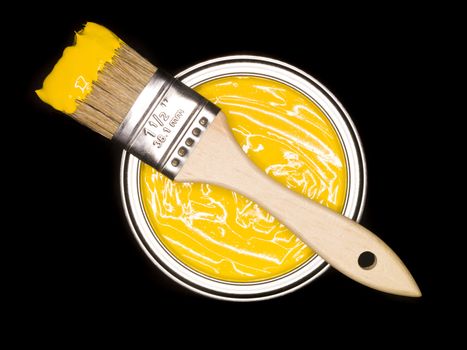 Yellow Paint can and brush from above on black background