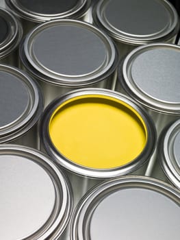 Paint cans full frame with a yellow can opened