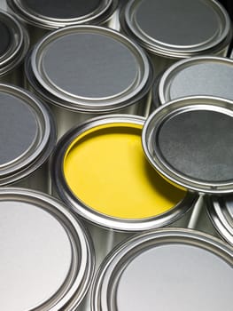 Paint cans full frame with a yellow can opened