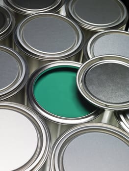 Paint cans full frame with a green can opened