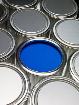 Paint cans full frame with a blue can opened