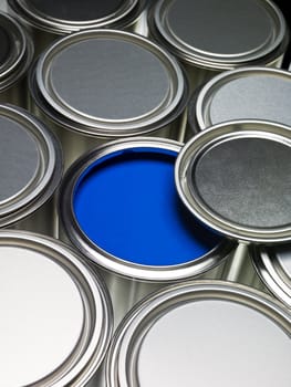Paint cans full frame with a blue can opened