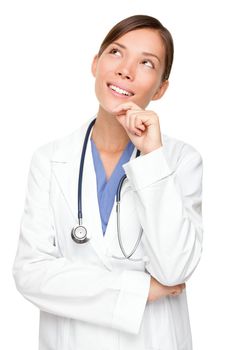 Thinking medical doctor looking up smiling. Multiracial Asian / Caucasian woman medical professional isolated on white background.
