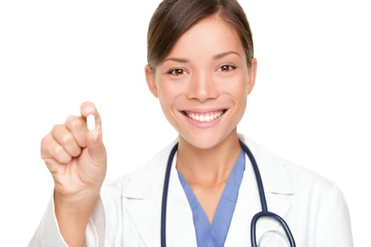 Doctor woman showing pill. Young female medical professional isolated on white background. Multiracial Asian / Caucasian model.