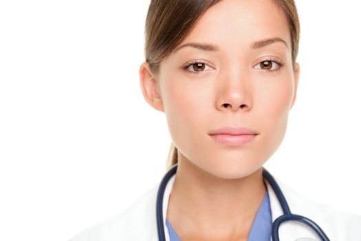 Medical doctor woman with serious expression. Multiracial Asian / Caucasian female medical professional isolated on white background.