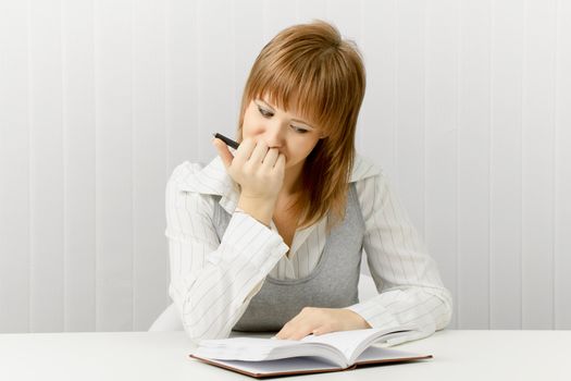 thoughtful girl with a notebook. Secretary in the office.

