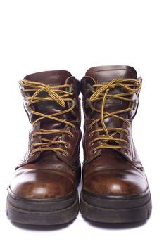 Close up view some old hiking boots isolated on a white background.