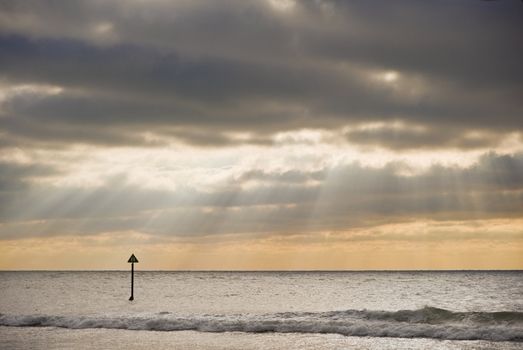 Beautiful sun beams penetrate dramatic sky during Winter's sunset