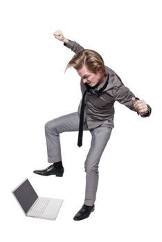 Young angry man destroys a computer.  Studio photo on white background.