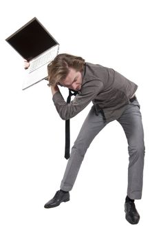 Young angry man destroys a computer.  Studio photo on white background.