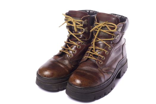 Close up view some old hiking boots isolated on a white background.