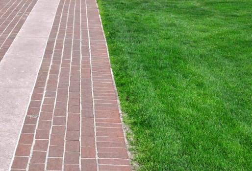 Brick pathway along green grass