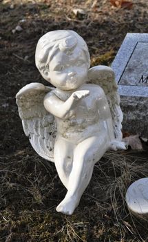 Gravesite - Cherub blowing a kiss - background