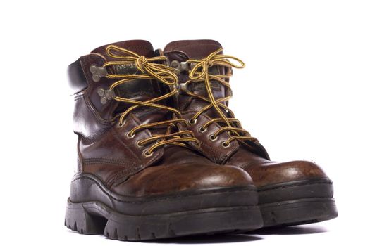 Close up view some old hiking boots isolated on a white background.