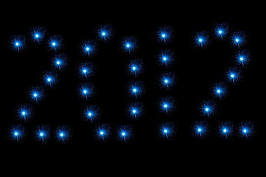 Many small illuminated blue fibre optic lamps arranged on black background to spell the number 2012