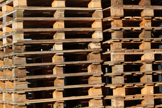 Close up of many brown wood palettes