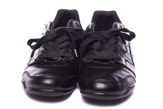 Close up view a modern pair of male black shoes isolated on a white background.