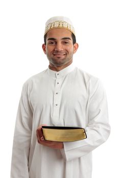 An ethnic mixed race man wearing cultural clothing is holding a book and smiling.