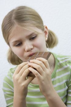 little pretty girl eating big chocolate bar