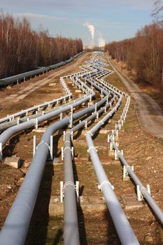 View of pipelines leading to the horizon with power-plant