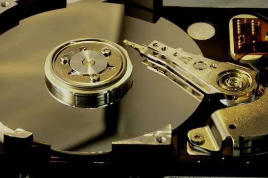 close view detail of the inside of a computer harddisk isolated on a white background.