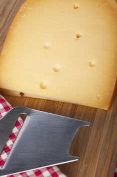 Dutch cheese block with metal cheese slicer.