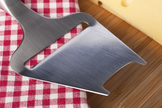 Close up of metal cheese slicer.