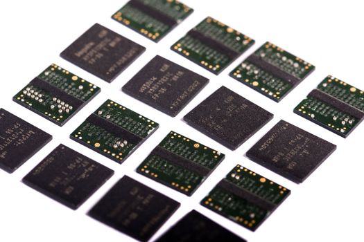 Close view of a bunch of computer memory chips isolated on a white background.