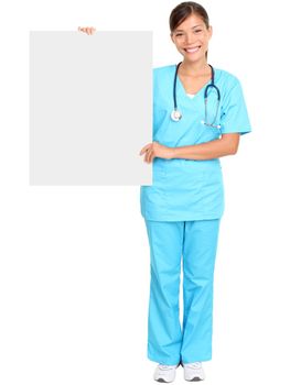 Medical doctor showing blank empty billboard sign poster. Young female doctor / nurse standing in full body isolated over white background. Asian / Caucasian woman.