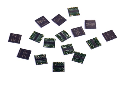 Close view of a bunch of computer memory chips isolated on a white background.