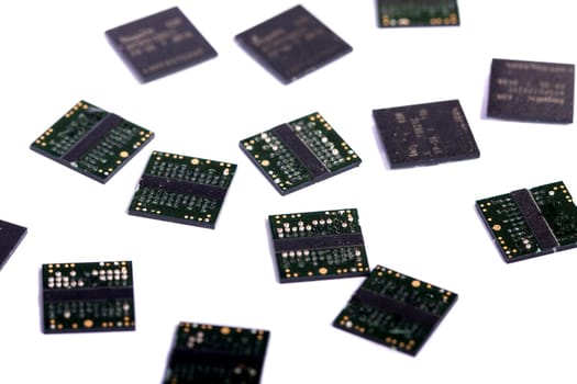 Close view of a bunch of computer memory chips isolated on a white background.