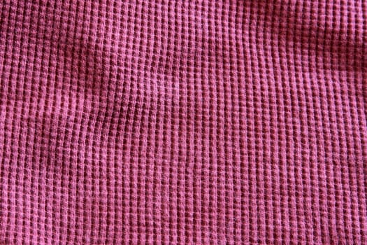 A close-up of a purple sweat-shirt.
