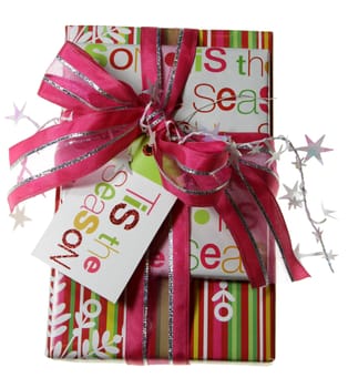 A beautifully wrapped Christmas present, featuring pink paper, stars and ribbon.
