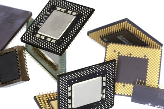 Close view detail of some computer microprocessors isolated on  a white background.