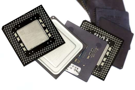 Close view detail of some computer microprocessors isolated on  a white background.