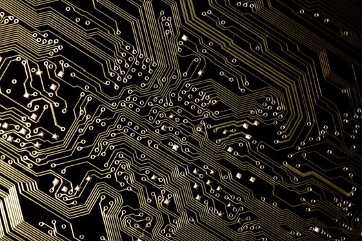 close view detail of   computer circuit chips on a golden light.