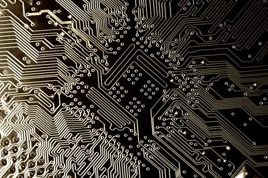 close view detail of   computer circuit chips on a golden light.