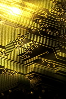 close view detail of   computer circuit chips on a golden light.