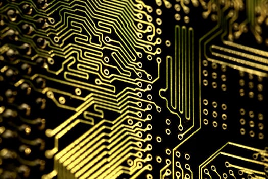 close view detail of   computer circuit chips on a golden light.