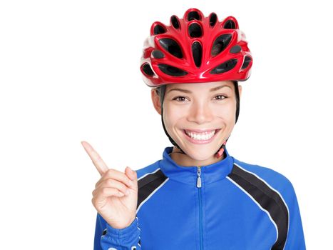 Bike woman wearing bicycle helmet pointing at copy space isolated on white background. Beautiful young asian chinese / white caucasian woman in biking outfit and red biking helmet