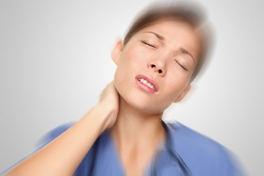 Nurse or young woman doctor having neck and back pain problems at work. Mixed-race Asian / Caucasian female model.