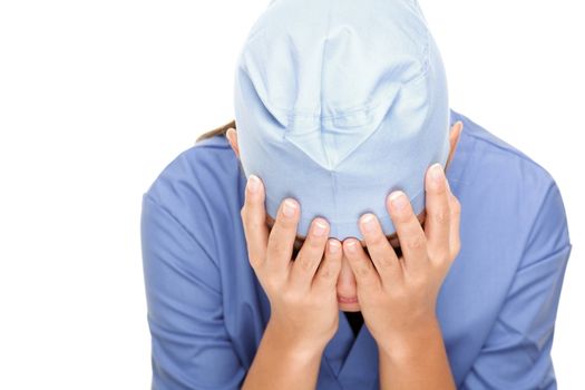 Crying unhappy upset medical nurse / doctor sad and depressed having stress breakdown. Isolated female Asian / Caucasian on white background.