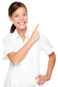 Beauty salon spa woman pointing isolated on white background. Portrait of beautiful young asian employee in uniform.